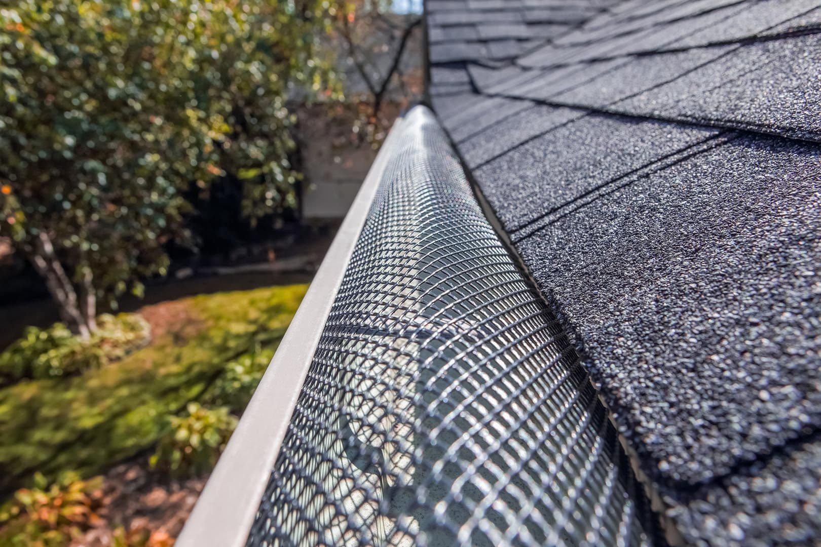 bigstock-Plastic-guard-over-gutter-on-a-387506794